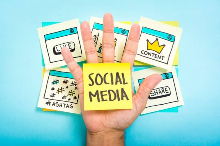 Social,Media,On,Hand,With,Blue,Background.,Content,Marketing